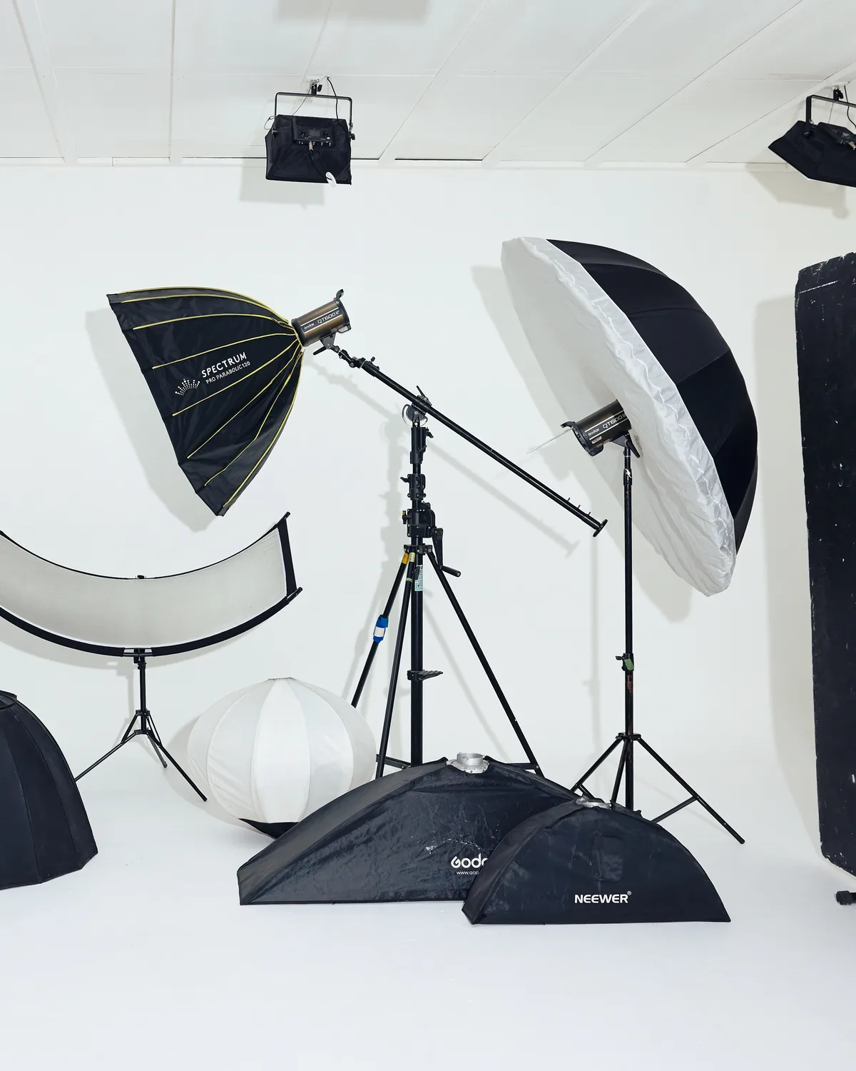 Lighting rig set up across the studio floor — softboxes, octabox and stands